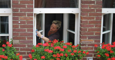 A woman washes windows